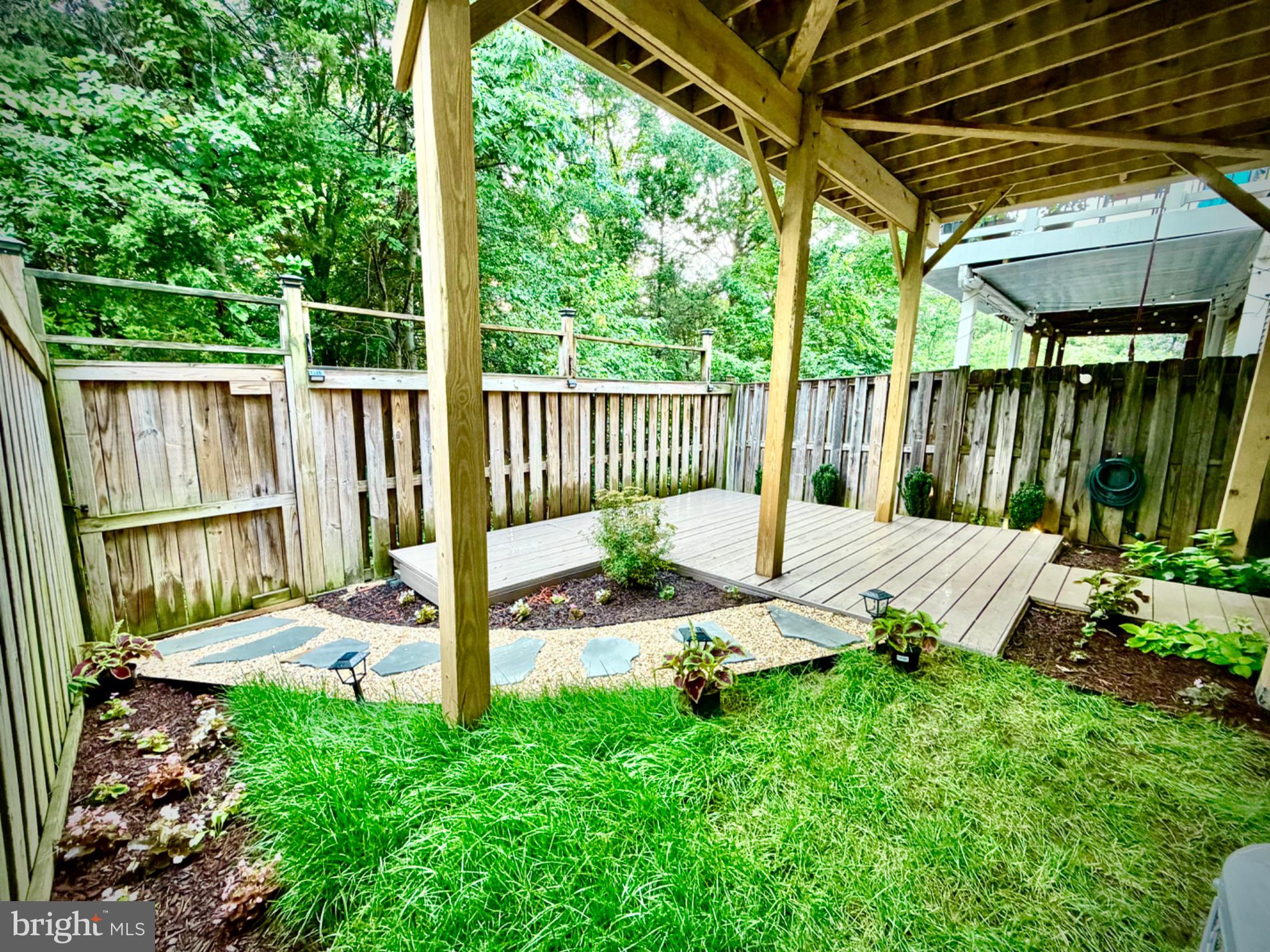 25333 Wakestone Terrace Chantilly, VA 20152 - Photo 5 of 109 Serene garden retreat with lush greenery.
