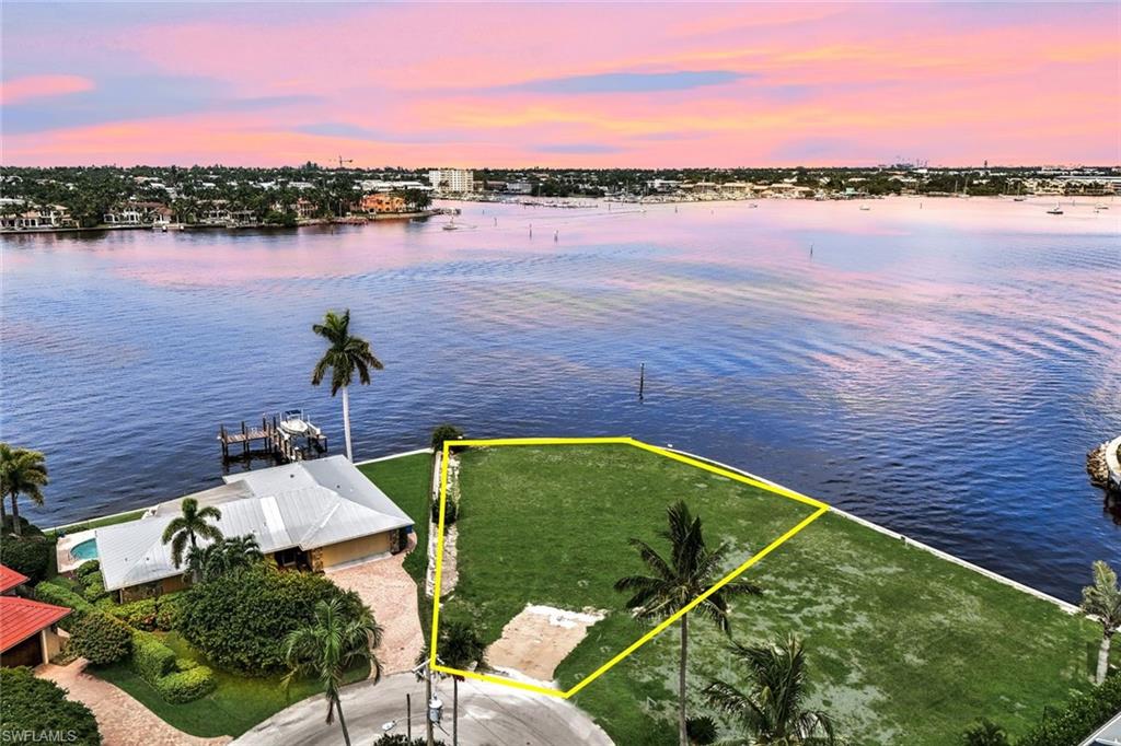 1303 Marlin Drive Naples, FL 34102 - Photo 3 of 15 Aerial view at dusk featuring a water view