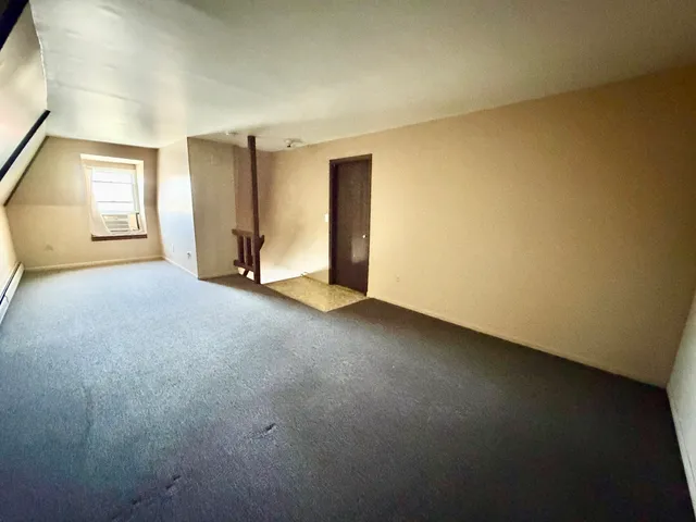 an empty room with a empty space and windows