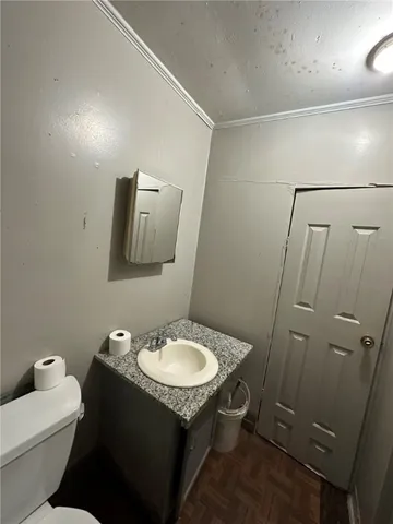 a bathroom with a sink toilet and mirror