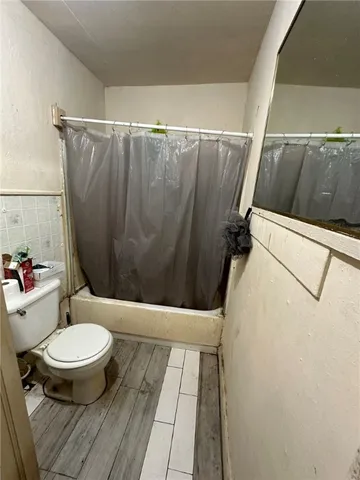 a white toilet sitting next to a small bathroom