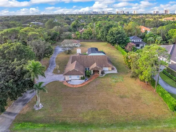 an aerial view of a house with a yard basket ball court and outdoor seating