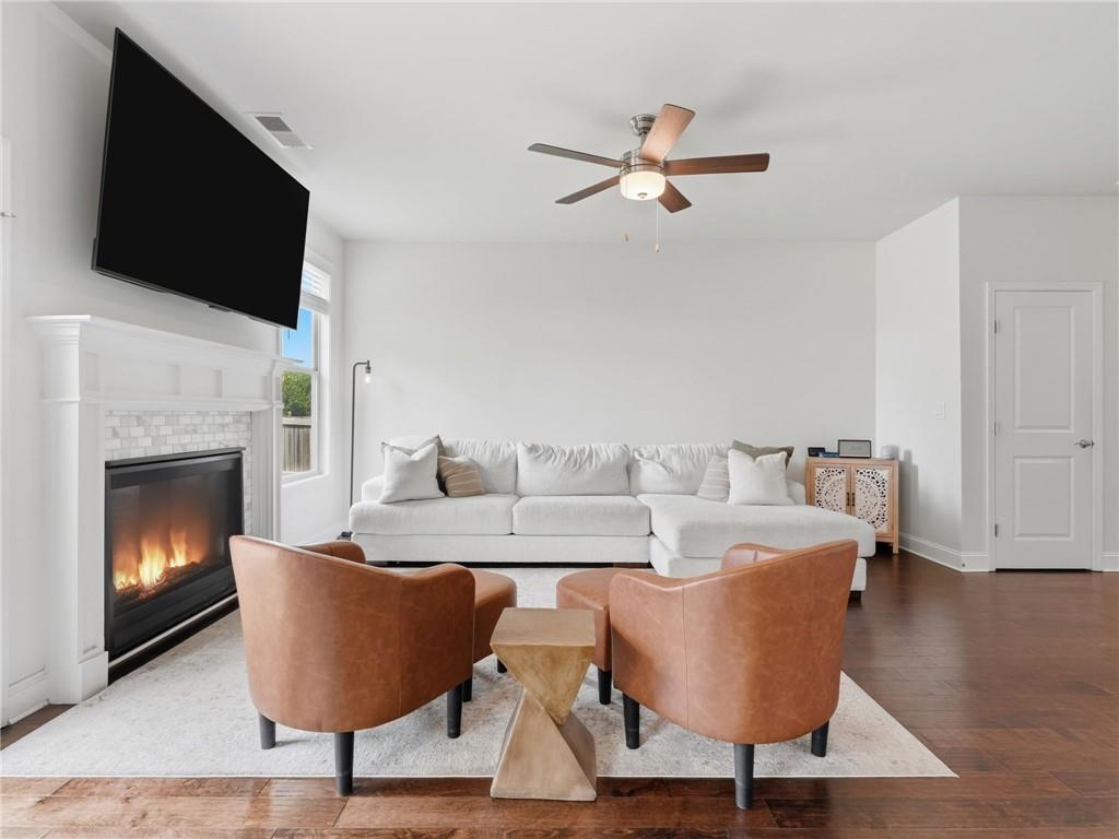 147 Fieldbrook Crossing Canton, GA 30115 - Photo 5 of 46 a living room with furniture a flat screen tv and a fireplace