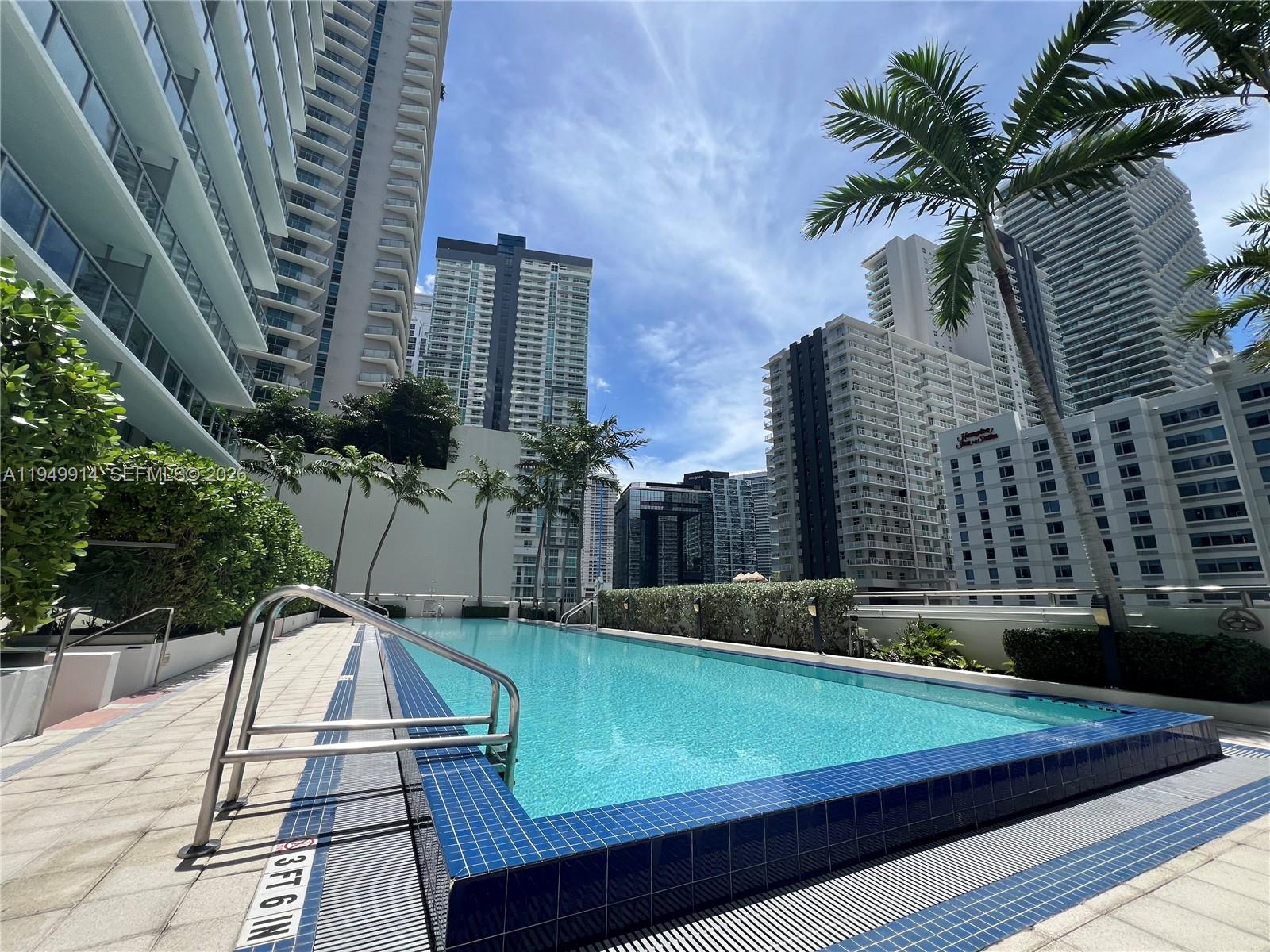 79 Southwest 12th Street, Unit 1704S Miami, FL 33130 - Photo 12 of 20 a view of a tennis ground with large trees