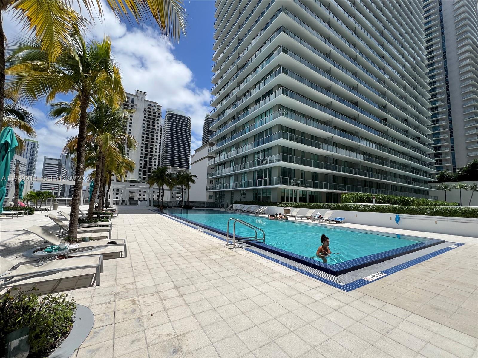 79 Southwest 12th Street, Unit 1704S Miami, FL 33130 - Photo 17 of 20 a view of outdoor space with swimming pool and furniture