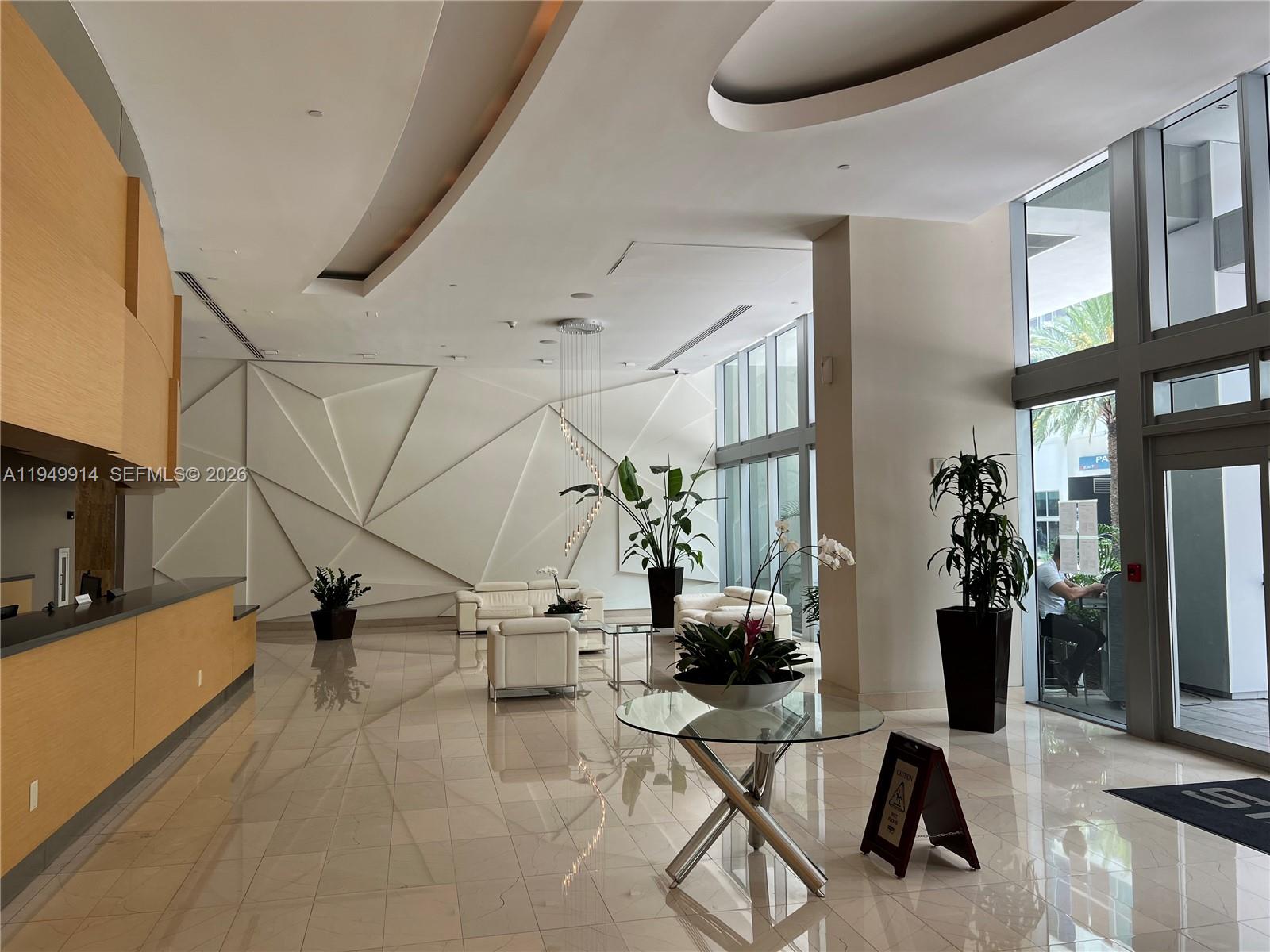 79 Southwest 12th Street, Unit 1704S Miami, FL 33130 - Photo 4 of 20 a view of a livingroom with furniture and a flat screen tv