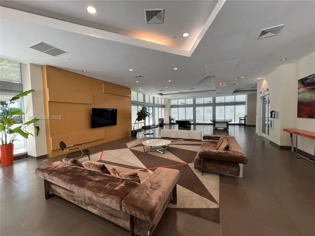 a balcony with pool table and chairs
