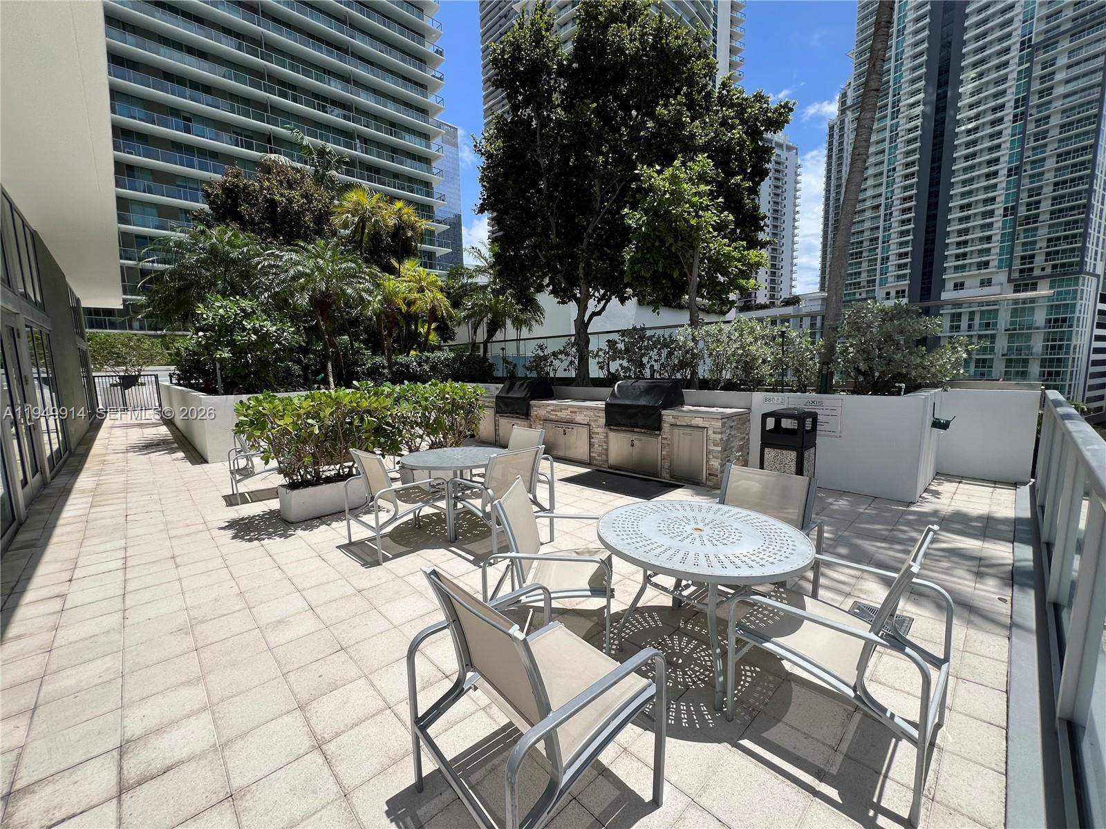 79 Southwest 12th Street, Unit 1704S Miami, FL 33130 - Photo 10 of 20 a view of a backyard with furniture and outdoor seating