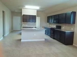a kitchen with stainless steel appliances a stove a sink and a microwave