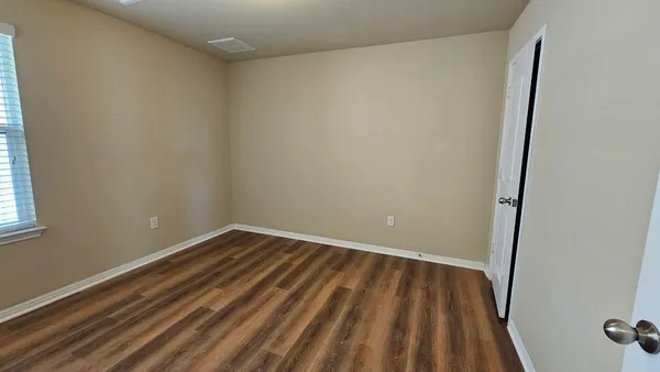 a view of a room with wooden floor and small space