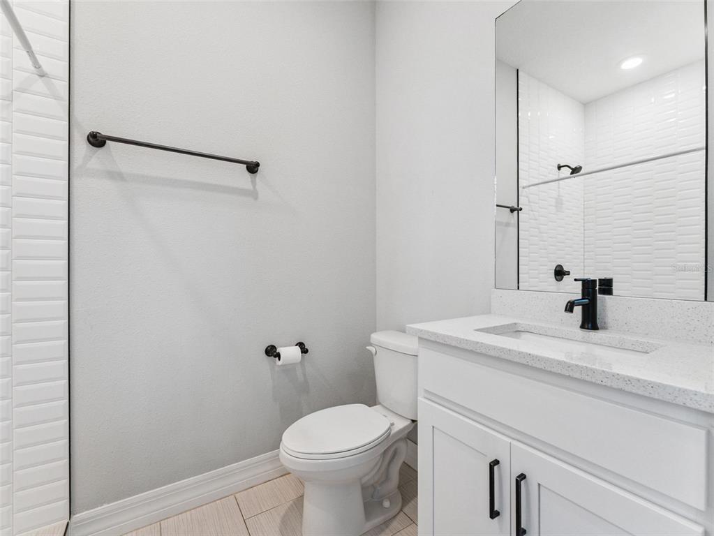 3421 West Horatio Street, Unit 109 Tampa, FL 33609 - Photo 14 of 20 a bathroom with a sink toilet vanity and shower
