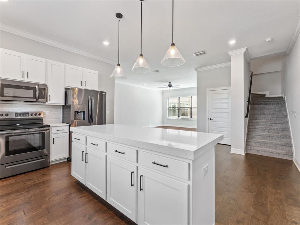 3421 West Horatio Street, Unit 109 Tampa, FL 33609 - Photo 7 of 20 a kitchen with stainless steel appliances kitchen island granite countertop a stove a sink and a refrigerator