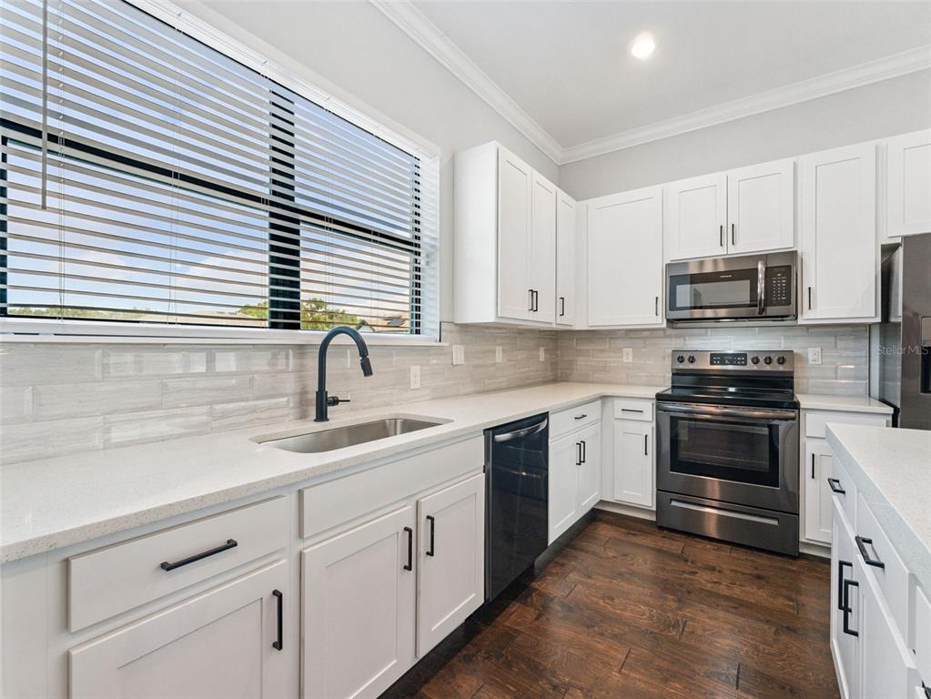 3421 West Horatio Street, Unit 109 Tampa, FL 33609 - Photo 8 of 20 a kitchen with appliances a sink and cabinets
