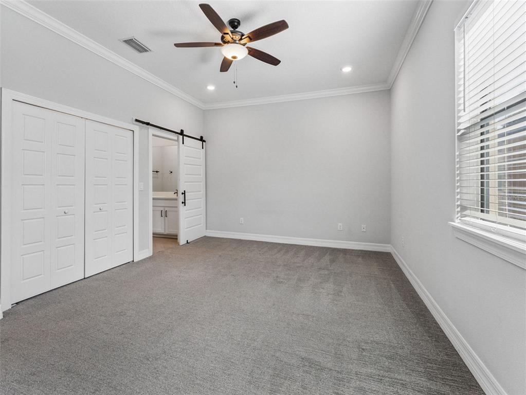 3421 West Horatio Street, Unit 109 Tampa, FL 33609 - Photo 9 of 20 an empty room with closet and windows