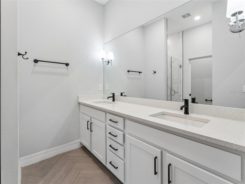 3421 West Horatio Street, Unit 109 Tampa, FL 33609 - Photo 10 of 20 a bathroom with a double vanity sink and a mirror