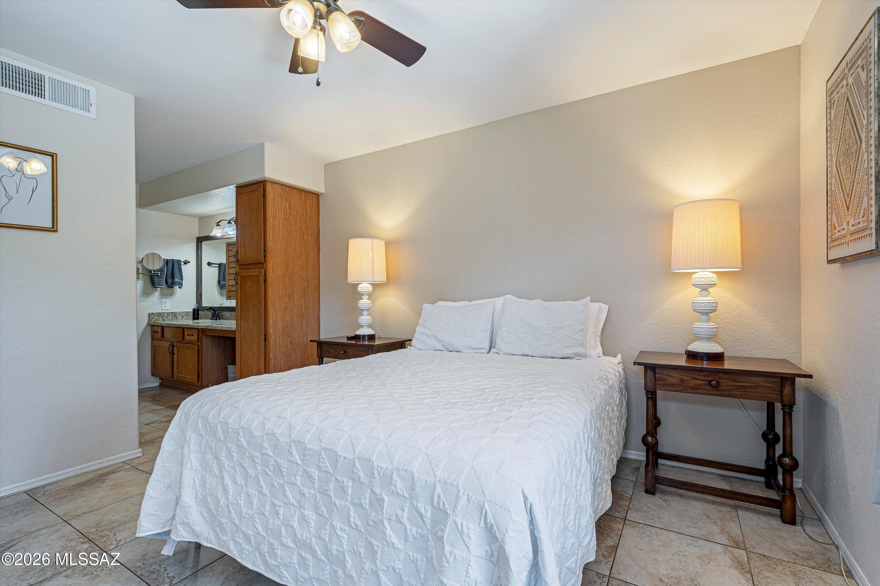 5800 North Kolb Road, Unit 5125 Tucson, AZ 85750 - Photo 13 of 34 a bedroom with a bed and a chandelier