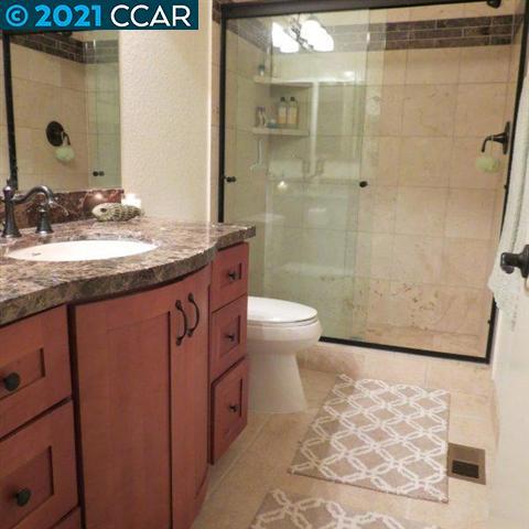 2683 Oak Road Walnut Creek, CA 94597 - Photo 16 of 19 a bathroom with a granite countertop sink a toilet and shower