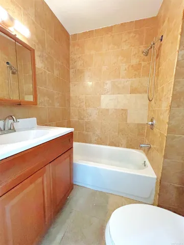 a bathroom with a sink a toilet and bathtub