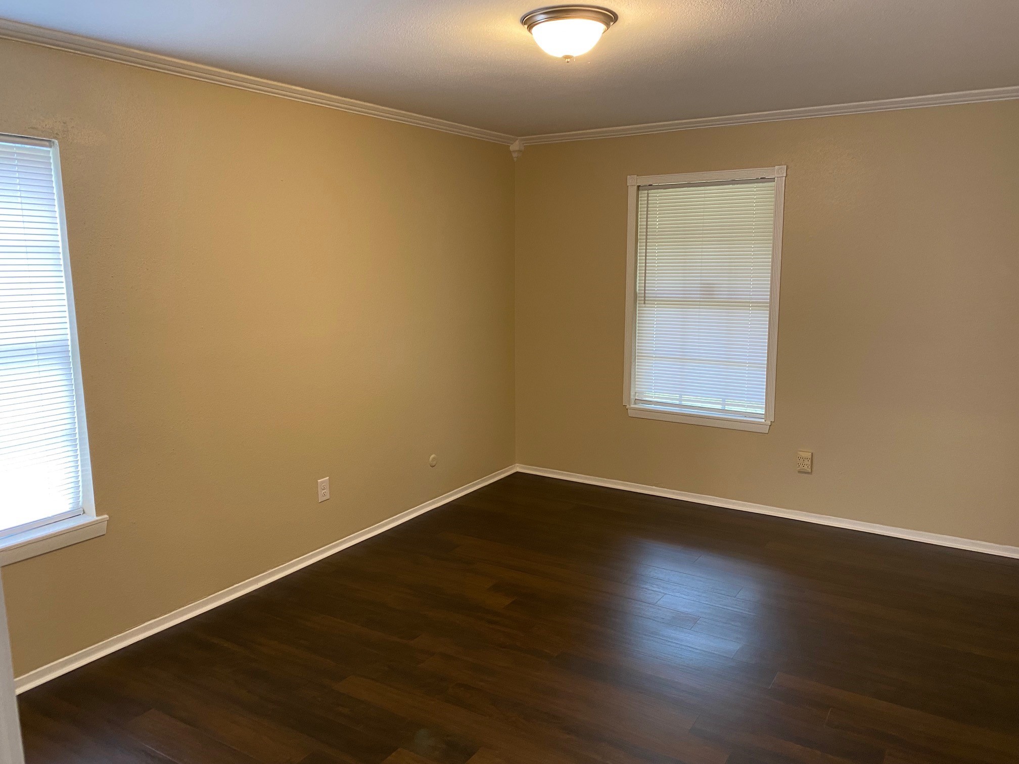 112 County Road 921 Angleton, TX 77515 - Photo 7 of 13 an empty room with wooden floor and windows