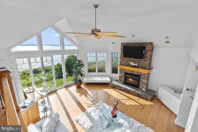 a kitchen with stainless steel appliances granite countertop a stove top oven a sink a dining table and chairs