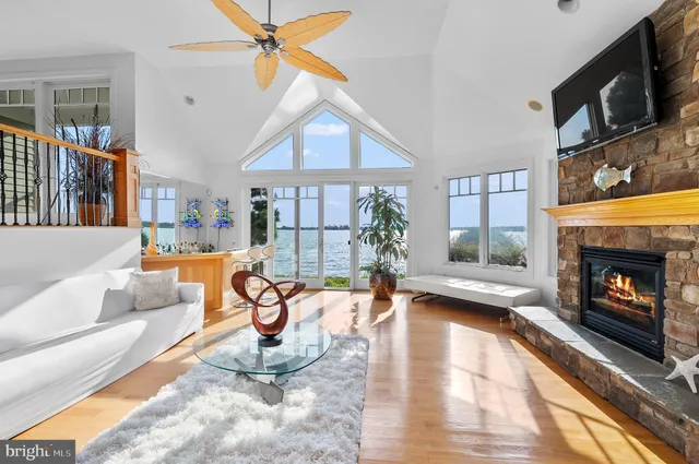 a kitchen with stainless steel appliances granite countertop a stove top oven a sink a dining table and chairs