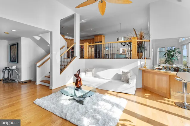 a living room with furniture a rug and white walls