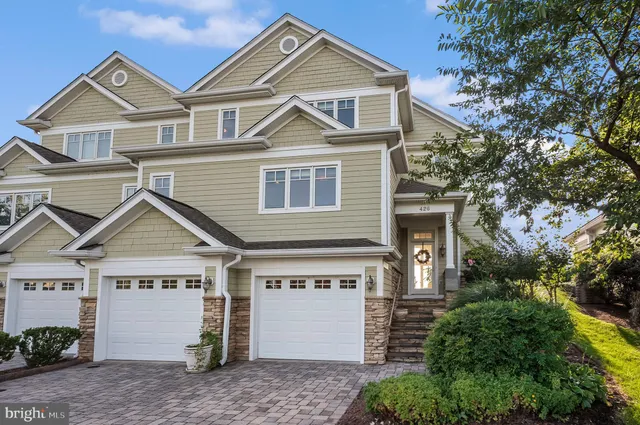 a view of a street with a house in the background