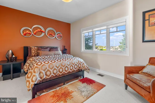 a bedroom with a bed and a large window