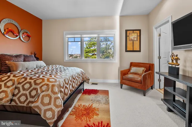 a spacious bathroom with a tub sink and a mirror