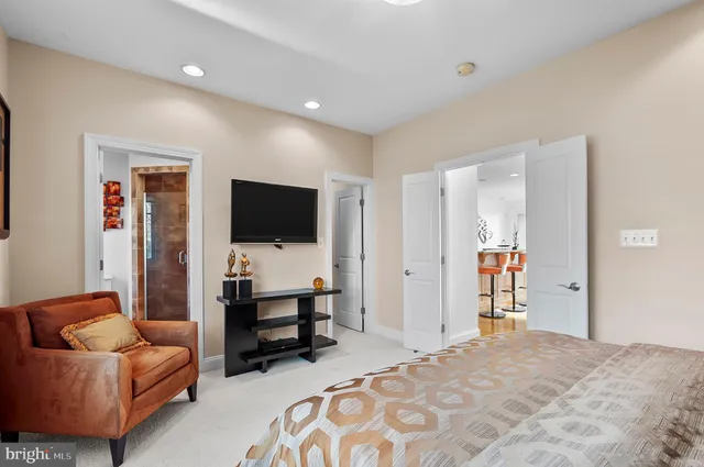a spacious bedroom with a bed and glass window