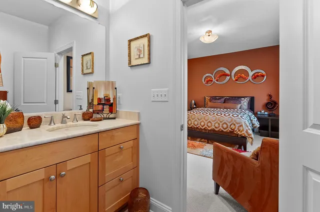 a bedroom with a bed a flat screen tv and a couch