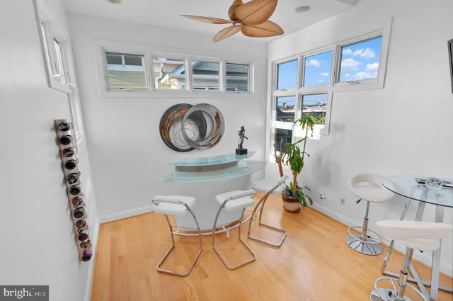 a living room with furniture a couch and paintings on the wall