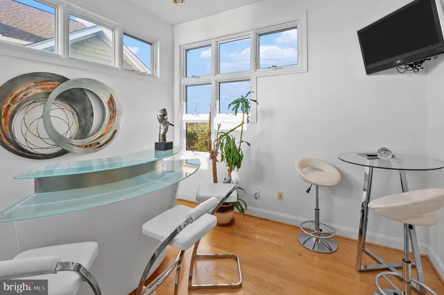 a view of a workspace with furniture and a window