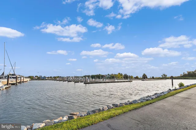 a living room with furniture a flat screen tv and a floor to ceiling window