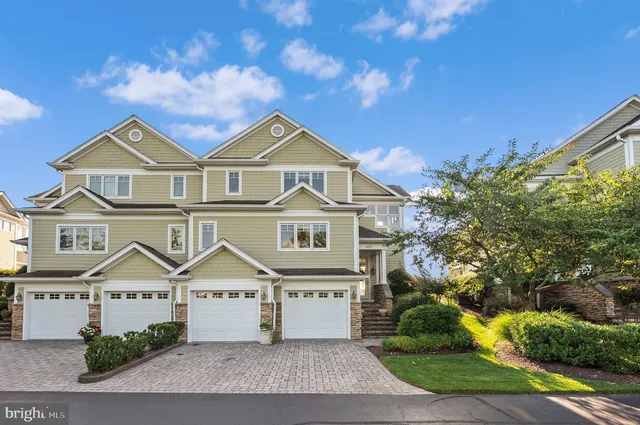 a living room with furniture a fireplace and a floor to ceiling window