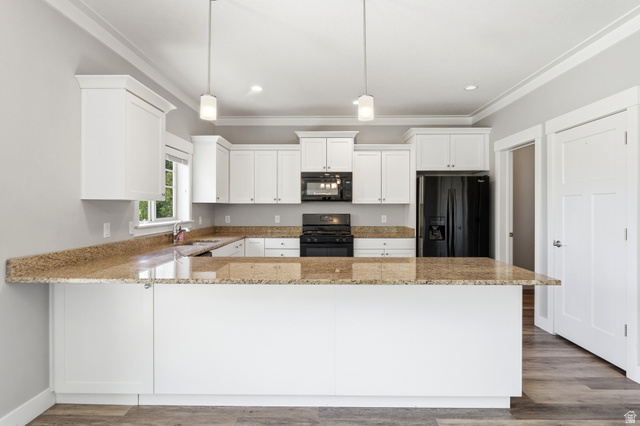 1614 Aspen Loop Provo, UT 84606 - Photo 13 of 47 Kitchen featuring white cabinetry, speckled countertops, black appliances, a central island, and wood-finish flooring