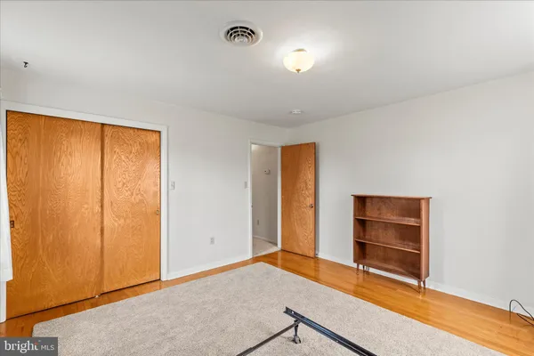 an empty room with a closet and window