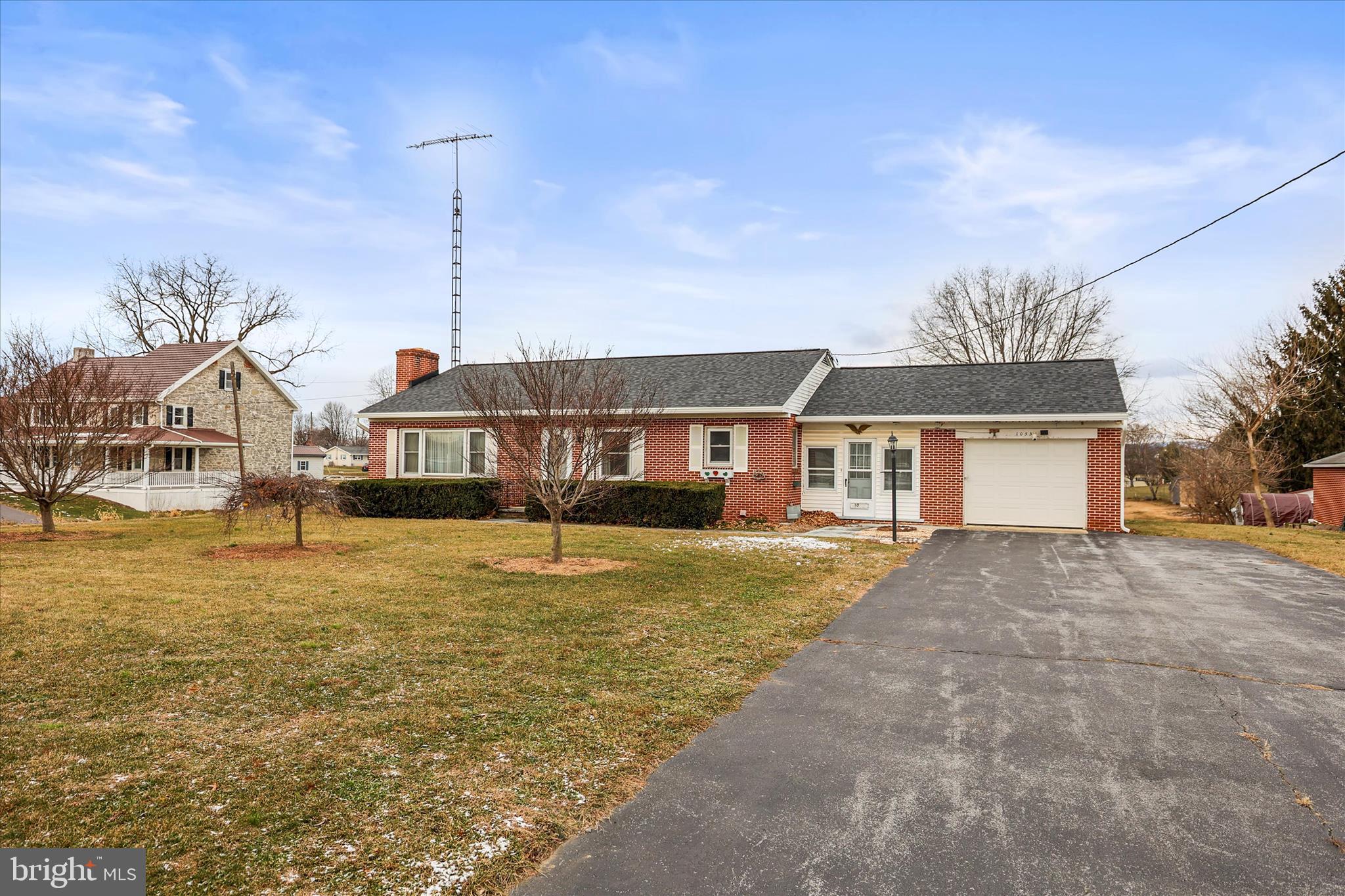 1055 South Main Street Chambersburg, PA 17201 - Photo 2 of 31 a front view of a house with a garden and lake view