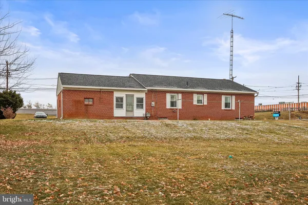 a view of a house next to a big yard
