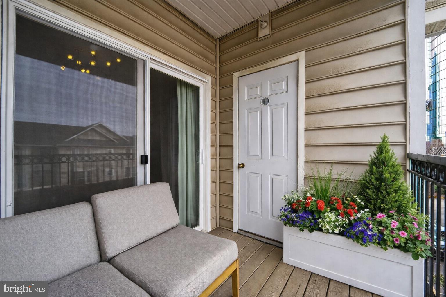 1601 Spring Gate Dr., Unit 1411 McLean, VA 22102 - Photo 14 of 39 a living room with furniture and flowers