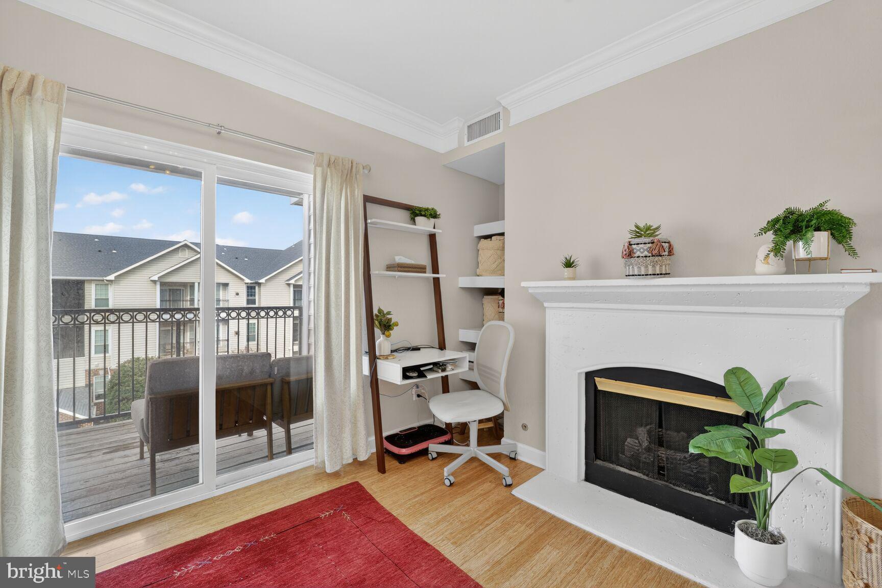 1601 Spring Gate Dr., Unit 1411 McLean, VA 22102 - Photo 2 of 39 a living room with furniture a fireplace and a potted plant
