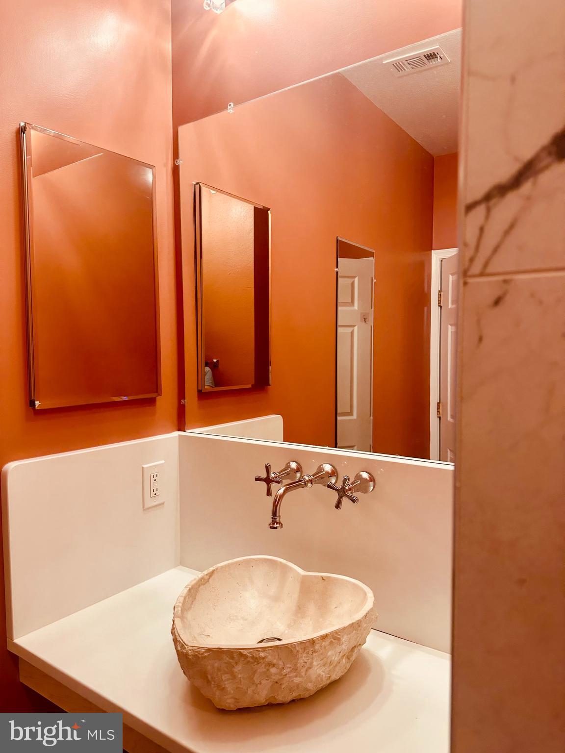 1601 Spring Gate Dr., Unit 1411 McLean, VA 22102 - Photo 21 of 39 a bathroom with a sink and a mirror