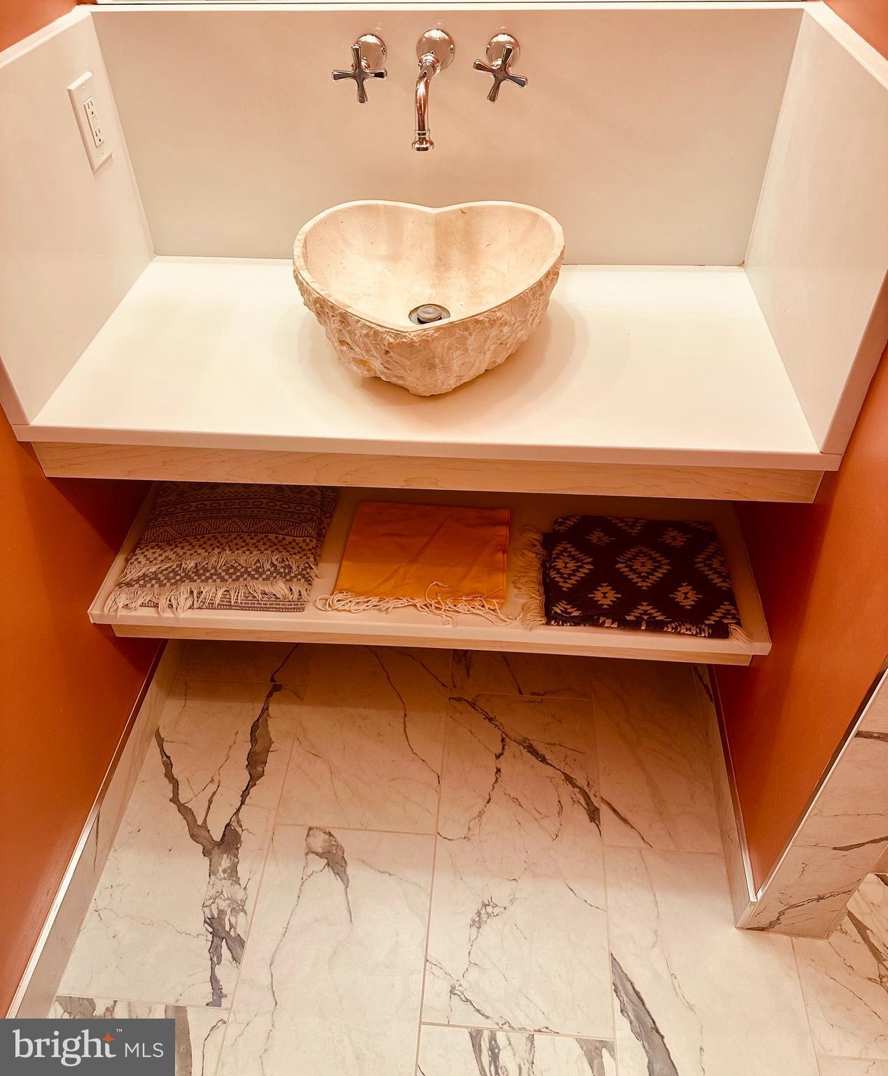 1601 Spring Gate Dr., Unit 1411 McLean, VA 22102 - Photo 22 of 39 a bathroom with a sink and a mirror