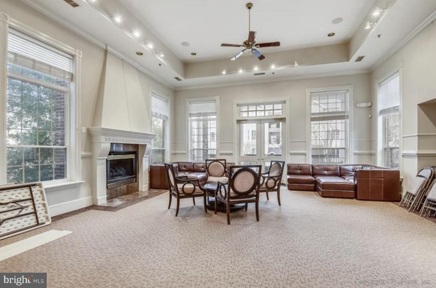 1601 Spring Gate Dr., Unit 1411 McLean, VA 22102 - Photo 26 of 39 a living room with furniture and a fireplace