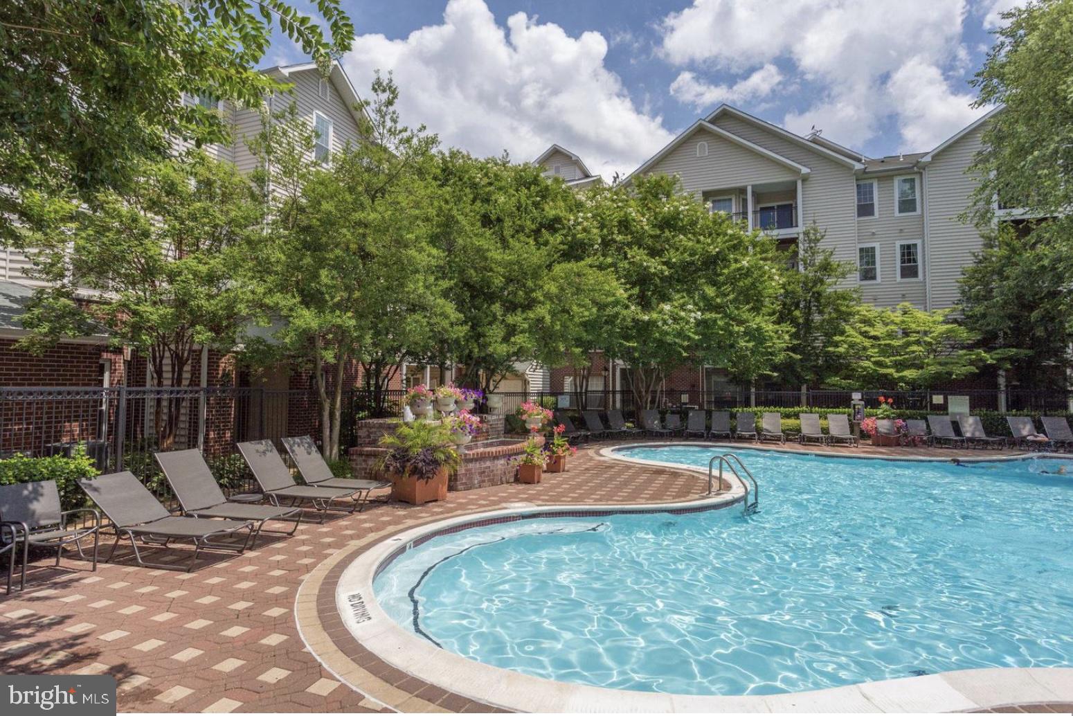 1601 Spring Gate Dr., Unit 1411 McLean, VA 22102 - Photo 29 of 39 a view of a swimming pool with sitting area