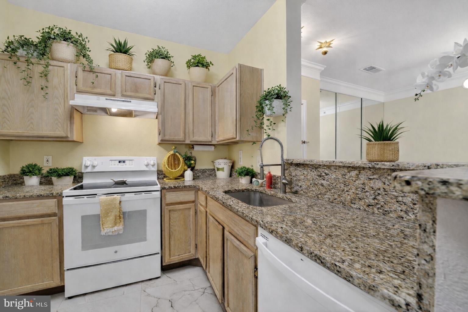 1601 Spring Gate Dr., Unit 1411 McLean, VA 22102 - Photo 3 of 39 a kitchen with a sink stove and cabinets