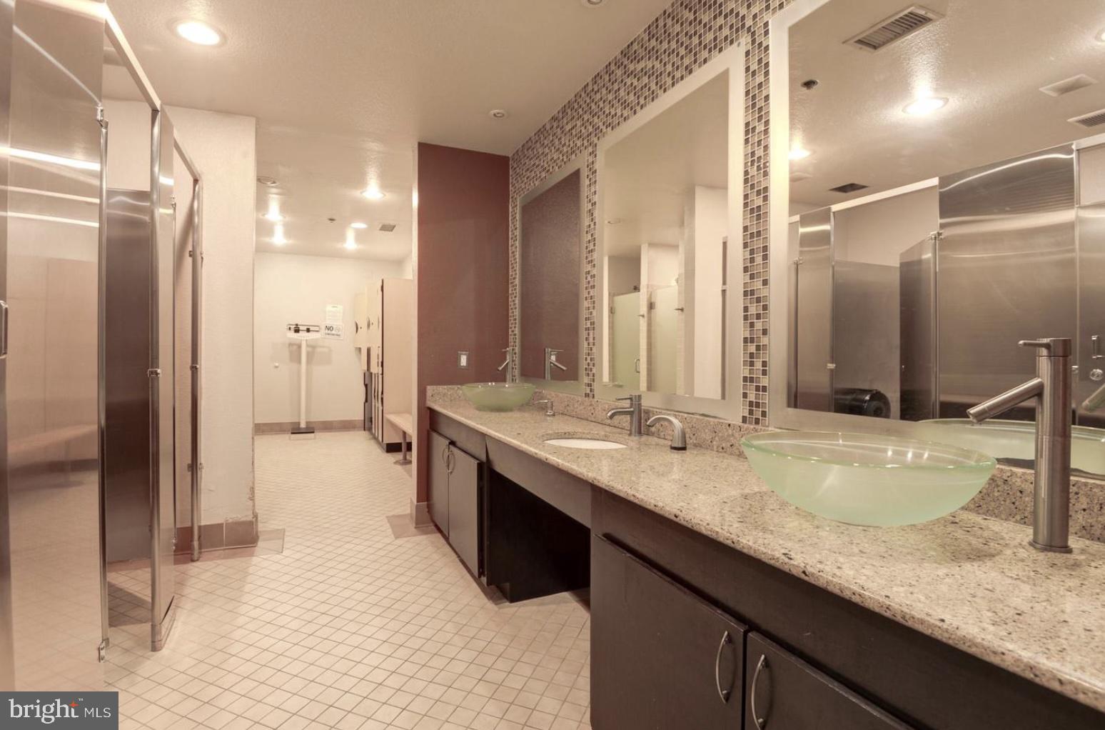 1601 Spring Gate Dr., Unit 1411 McLean, VA 22102 - Photo 32 of 39 a bathroom with a granite countertop double vanity sink and a mirror