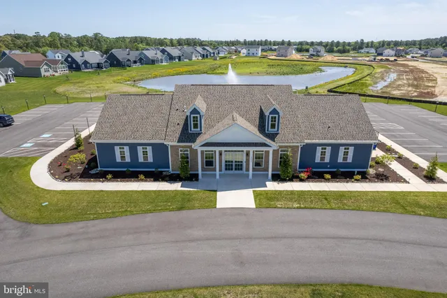 a view of a house with a swimming pool and a yard