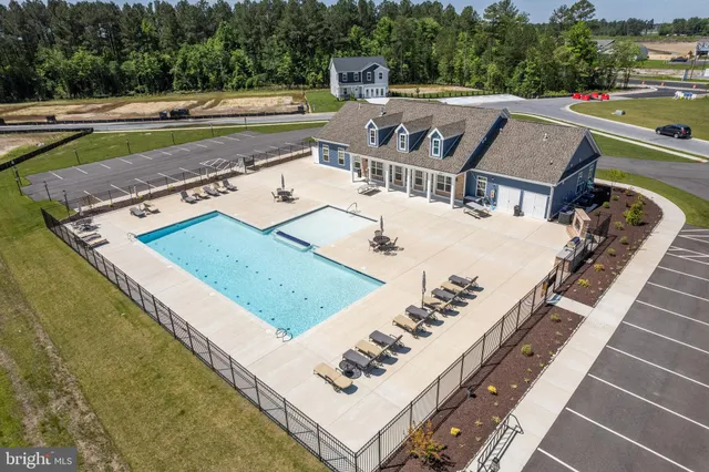 an aerial view of a house with a garden and swimming pool