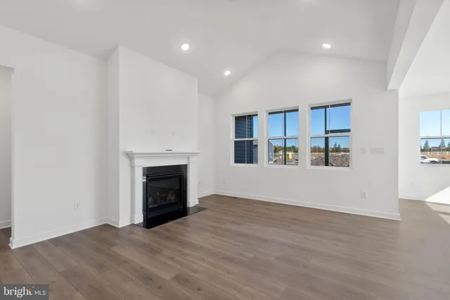 a view of a livingroom with an empty space and a fireplace